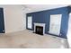 Cozy living room with neutral carpet, fireplace, and plenty of natural light from two windows at 4909 Willow Tree Ln, Clayton, NC 27520