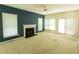 Spacious living room features a cozy fireplace, natural lighting, and ceiling fan at 4909 Willow Tree Ln, Clayton, NC 27520