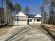 Charming single-Gathering home featuring a brick facade, attached garage, and well-lit covered porch at 5004 Macleod Pl, Zebulon, NC 27597