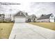 Home exterior with driveway and well-maintained lawn at 5004 Macleod Pl, Zebulon, NC 27597