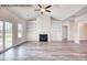 Living area with vaulted ceilings, fireplace with built-in shelving, and sliding glass door to the backyard at 5004 Macleod Pl, Zebulon, NC 27597