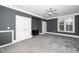 Bedroom features neutral carpeting, white trim and gray walls with a large window for natural light at 501 Finsbury St # 100, Durham, NC 27703