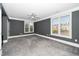 Spacious bedroom features neutral carpeting, gray walls, white trim, and a ceiling fan at 501 Finsbury St # 100, Durham, NC 27703