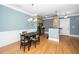 The dining area has wood floors, a chandelier, stainless appliances, and a breakfast bar at 501 Finsbury St # 100, Durham, NC 27703