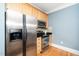 The kitchen has stainless appliances, wooden cabinets, and granite countertops at 501 Finsbury St # 100, Durham, NC 27703