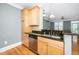 Kitchen features stainless steel appliances, wood cabinets, granite countertops, and a breakfast bar at 501 Finsbury St # 100, Durham, NC 27703