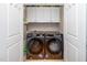 The laundry room includes a pair of front load washer and dryers with upper cabinets at 501 Finsbury St # 100, Durham, NC 27703