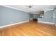 Open-concept living area with hardwood floors, fan, and views to the kitchen and dining space at 501 Finsbury St # 100, Durham, NC 27703
