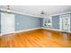 Inviting living room with hardwood floors, fan, natural light, and access to an outside patio at 501 Finsbury St # 100, Durham, NC 27703