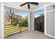 Covered outdoor patio space featuring black metal railings, a ceiling fan, and a clear view of the community at 501 Finsbury St # 100, Durham, NC 27703