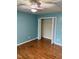 Bedroom featuring a closet with paneled folding doors and hardwood floors at 501 Liberty Rose Dr, Morrisville, NC 27560