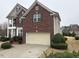 Red brick house featuring well-maintained landscaping and an attached two-car garage at 501 Liberty Rose Dr, Morrisville, NC 27560