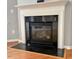 A fireplace with a black marble surround and a wooden mantle at 501 Liberty Rose Dr, Morrisville, NC 27560