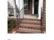 Brick steps leading up to the front porch with a metal railing and small shrubs at 501 Liberty Rose Dr, Morrisville, NC 27560