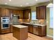 Gourmet kitchen with a kitchen island, stainless steel appliances, and sleek wooden cabinetry at 501 Liberty Rose Dr, Morrisville, NC 27560