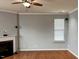Living room featuring a fireplace, ceiling fan, and windows at 501 Liberty Rose Dr, Morrisville, NC 27560