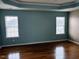 Spacious main bedroom features hardwood flooring, neutral walls, and tray ceiling at 501 Liberty Rose Dr, Morrisville, NC 27560