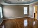 Spacious main bedroom features hardwood flooring, neutral walls, tray ceiling, and ensuite at 501 Liberty Rose Dr, Morrisville, NC 27560