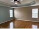 Spacious main bedroom features hardwood flooring, neutral walls, and tray ceiling at 501 Liberty Rose Dr, Morrisville, NC 27560
