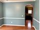 Open living area features hardwood floors and a seamless transition to a brightly lit kitchen at 501 Liberty Rose Dr, Morrisville, NC 27560