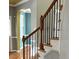 Elegant staircase with wooden handrail and decorative iron spindles, seamlessly connecting to the upper level at 501 Liberty Rose Dr, Morrisville, NC 27560