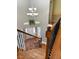 Hardwood stairway features dark ornate metal railings, natural light, and a decorative light fixture at 501 Liberty Rose Dr, Morrisville, NC 27560
