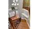 Hardwood stairway features dark ornate metal railings, natural light, and a decorative light fixture at 501 Liberty Rose Dr, Morrisville, NC 27560