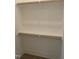 Empty walk-in closet with wood shelving and rods at 505 Ansley Ridge Rdg, Cary, NC 27518