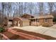 Inviting two-story home featuring a brick facade, attached garage, and a well-maintained front yard landscape at 524 Farmington Woods Dr, Cary, NC 27511