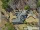 Aerial view of the property showcasing the expansive lot, manicured landscaping, and architecture at 601 Golfers Vw, Pittsboro, NC 27312