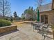 Spacious backyard with a stone patio, manicured lawn, and privacy landscaping at 601 Golfers Vw, Pittsboro, NC 27312
