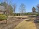 Landscaped backyard featuring garden beds, lush lawn, and mature trees at 601 Golfers Vw, Pittsboro, NC 27312