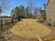 Expansive backyard with lush lawn, a fence, and mature trees at 601 Golfers Vw, Pittsboro, NC 27312