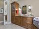 Bathroom featuring granite counters, custom cabinets, and decorative mirrors at 601 Golfers Vw, Pittsboro, NC 27312