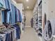 Large walk-in closet featuring built-in shelving and hanging rods at 601 Golfers Vw, Pittsboro, NC 27312