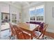 Cozy dining room with hardwood floors, white trim, and a large window provides natural light at 601 Golfers Vw, Pittsboro, NC 27312