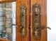 Close-up of ornate brass door handles on solid wood double doors at 601 Golfers Vw, Pittsboro, NC 27312