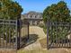Gated entryway with brick walkway leading to a grand home at 601 Golfers Vw, Pittsboro, NC 27312