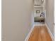 Hallway leading to a bedroom, features hardwood floors, neutral walls, and simple trim at 601 Golfers Vw, Pittsboro, NC 27312