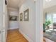 Long hallway with art on the walls, hardwood floors and a large archway at 601 Golfers Vw, Pittsboro, NC 27312