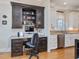 Built-in desk area with drawers and shelves plus a kitchen area with granite countertops at 601 Golfers Vw, Pittsboro, NC 27312
