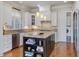 Open kitchen featuring custom cabinetry, a central island, and modern stainless steel appliances at 601 Golfers Vw, Pittsboro, NC 27312