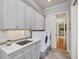 Laundry room with granite countertop, under cabinet lights and washer/dryer at 601 Golfers Vw, Pittsboro, NC 27312