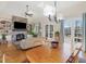 Bright living space with a stone fireplace, built-in shelving, and French doors leading to the outside at 601 Golfers Vw, Pittsboro, NC 27312