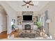 Bright living room with a stone fireplace, built-in bookshelves, and lots of natural light at 601 Golfers Vw, Pittsboro, NC 27312