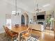 Open-concept living area featuring a stone fireplace, built-in shelves, and cathedral ceilings at 601 Golfers Vw, Pittsboro, NC 27312