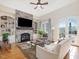 Bright living room with stone fireplace, built-in shelves, and French doors at 601 Golfers Vw, Pittsboro, NC 27312