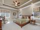 Serene bedroom with tray ceiling, carpet floors, and an array of windows for natural light at 601 Golfers Vw, Pittsboro, NC 27312