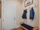 Mudroom with a built in bench and coat rack by the door at 601 Golfers Vw, Pittsboro, NC 27312