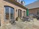 Stone patio includes a wrought iron table set for four, and a built-in grill at 601 Golfers Vw, Pittsboro, NC 27312